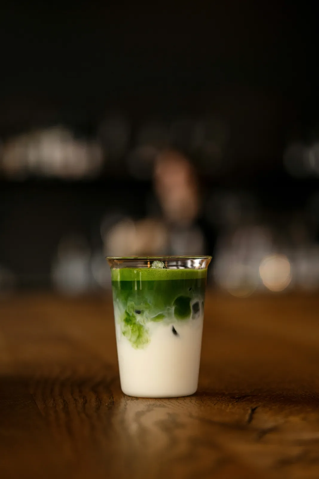 Iced matcha latte layered with milk in a glass